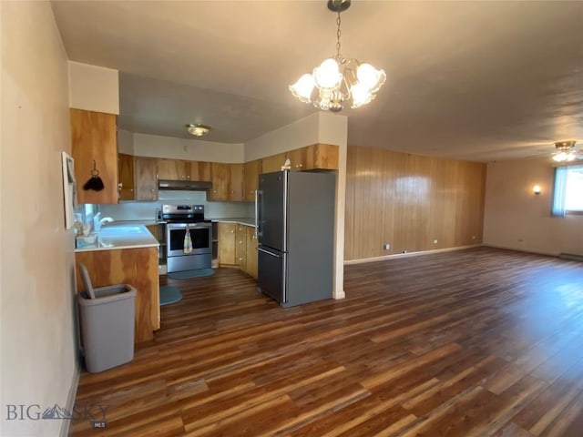 209 2nd St E, Whitehall, MT 59759 - kitchen featuring appliances with stainless steel finishes, a chandelier, dark wood finished floors, light countertops, and a sink