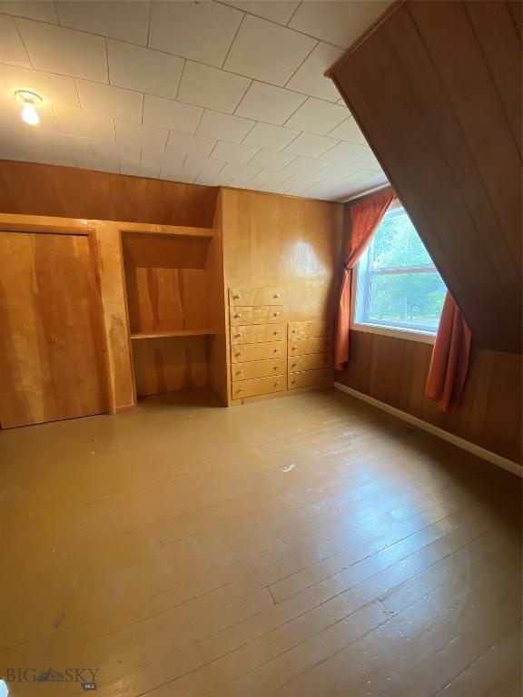 209 2nd St E, Whitehall, MT 59759 - additional living space featuring wooden walls and hardwood / wood-style floors