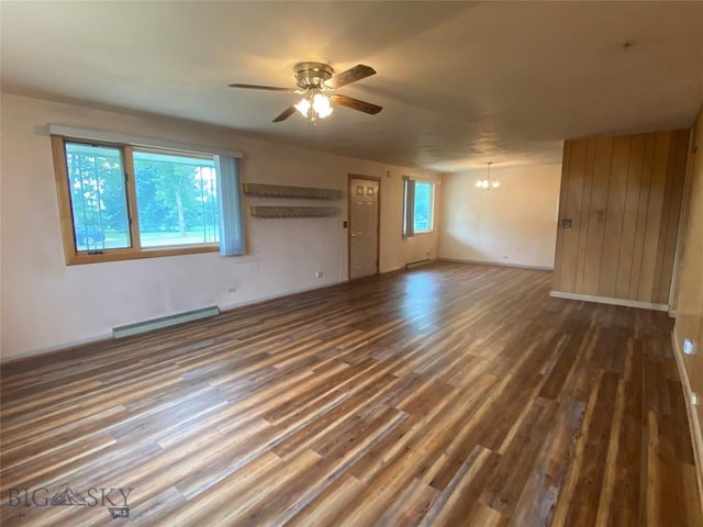 209 2nd St E, Whitehall, MT 59759 - empty room with a baseboard heating unit, a chandelier, ceiling fan, wood finished floors, and baseboards
