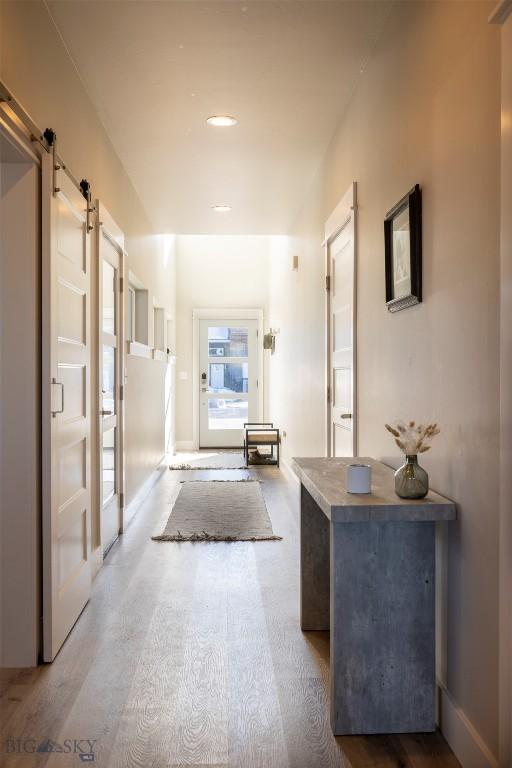 309 Meriwether, Bozeman, MT 59718 - hallway with recessed lighting, a barn door, and wood finished floors