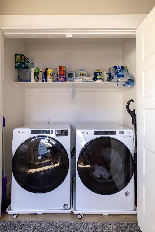 clothes washing area featuring washer and clothes dryer and laundry area