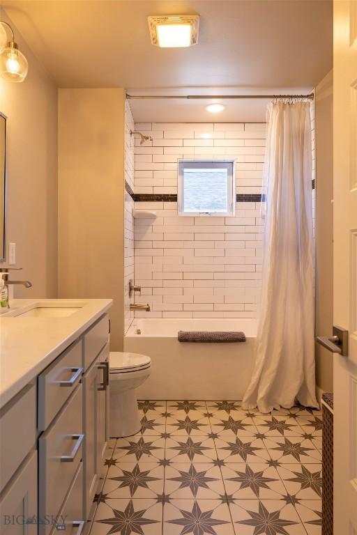 309 Meriwether, Bozeman, MT 59718 - full bath with tile patterned floors, shower / bath combo with shower curtain, vanity, and toilet