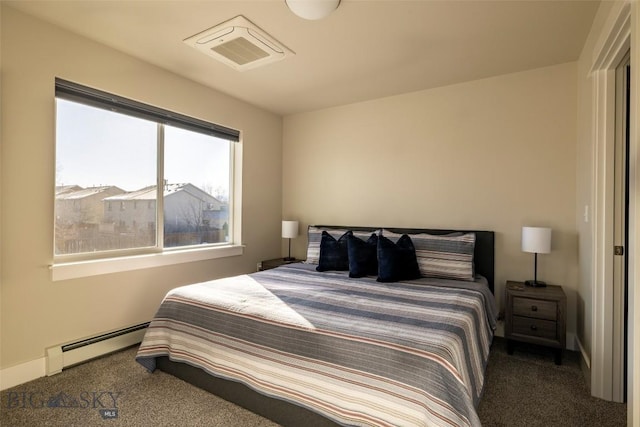 bedroom with carpet, visible vents, baseboard heating, and baseboards