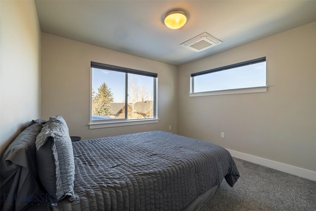 carpeted bedroom featuring visible vents and baseboards