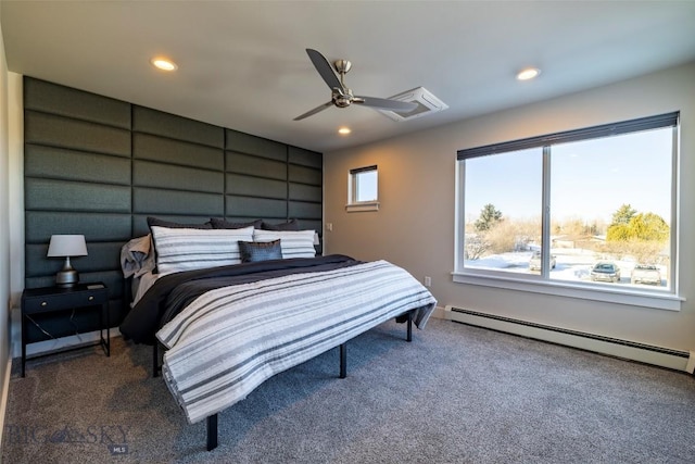 bedroom with baseboard heating, multiple windows, and carpet floors