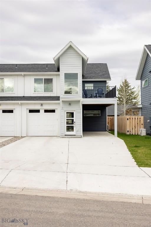 309 Meriwether, Bozeman, MT 59718 - view of front of property with board and batten siding, a garage, fence, a balcony, and concrete driveway