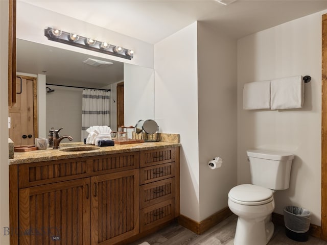 full bathroom featuring visible vents, toilet, curtained shower, wood finished floors, and baseboards