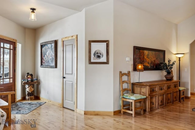 foyer entrance featuring wood finished floors and baseboards