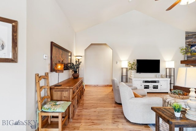 living room with high vaulted ceiling, light wood-type flooring, and ceiling fan