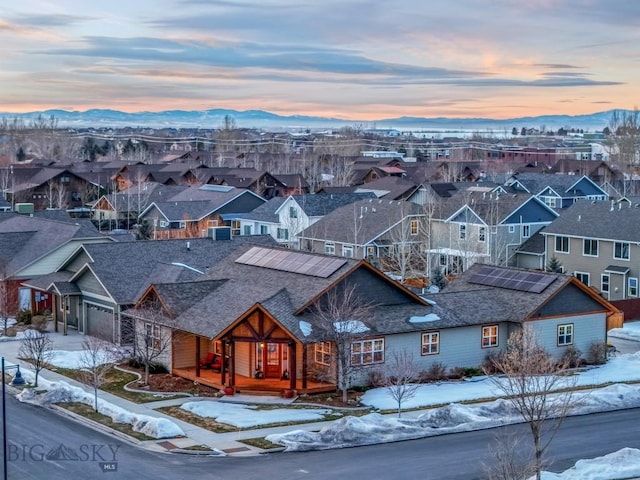 snowy aerial view with a residential view