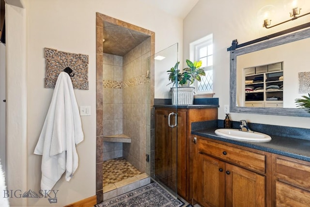 full bath with a shower stall and vanity