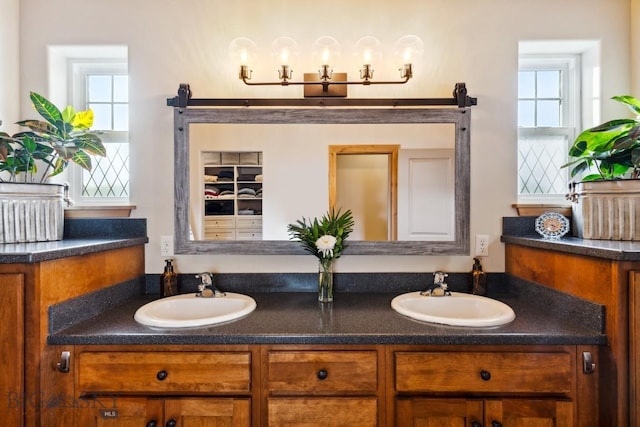 bathroom featuring a sink and double vanity