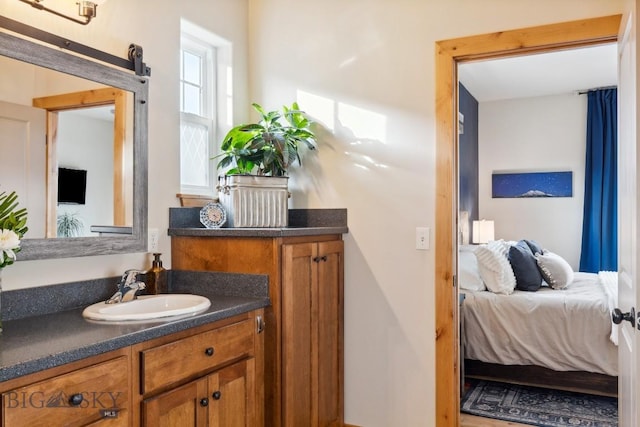 bathroom with connected bathroom and vanity