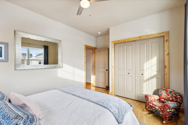 bedroom with a closet, light wood-type flooring, and ceiling fan