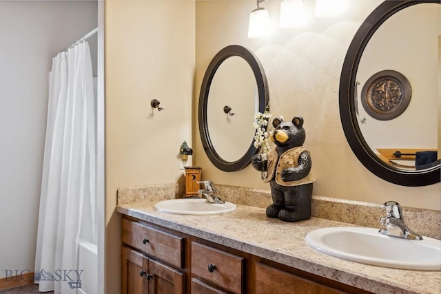 full bath featuring a sink and double vanity