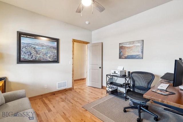 home office featuring light wood-type flooring, visible vents, baseboards, and ceiling fan