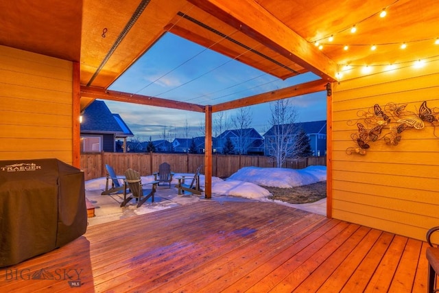 deck featuring area for grilling, an outdoor fire pit, and fence