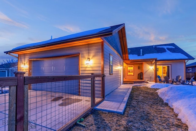 exterior space featuring a garage and fence