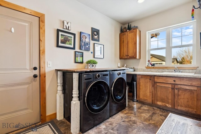 laundry area featuring cabinet space, washing machine and dryer, and a sink