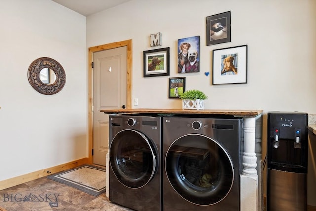 laundry room with baseboards, independent washer and dryer, and cabinet space