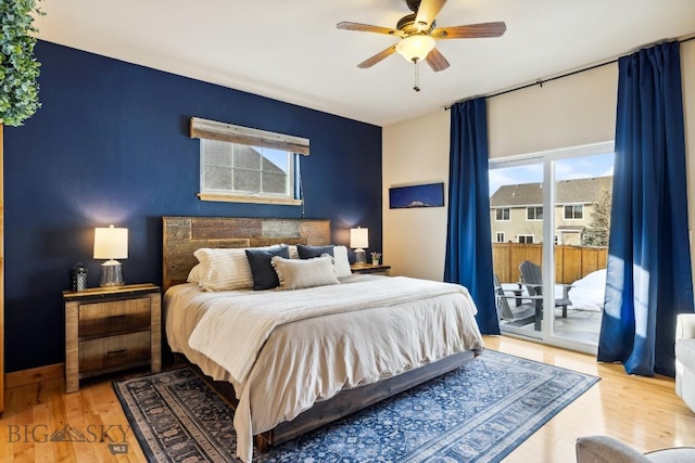 bedroom with wood finished floors, a ceiling fan, and access to outside