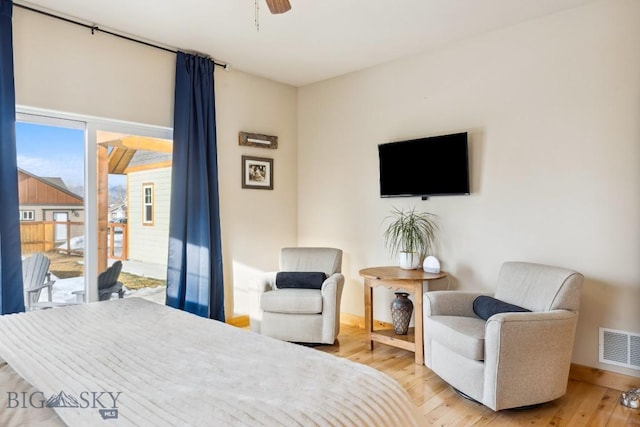 bedroom with a ceiling fan, baseboards, visible vents, and light wood finished floors