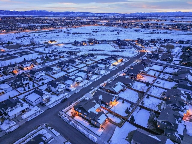 snowy aerial view with a mountain view