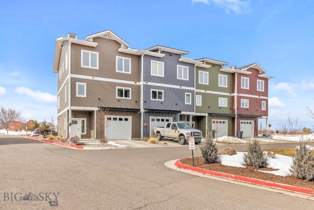 multi unit property featuring a chimney and a garage