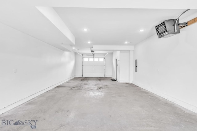 garage featuring recessed lighting and baseboards