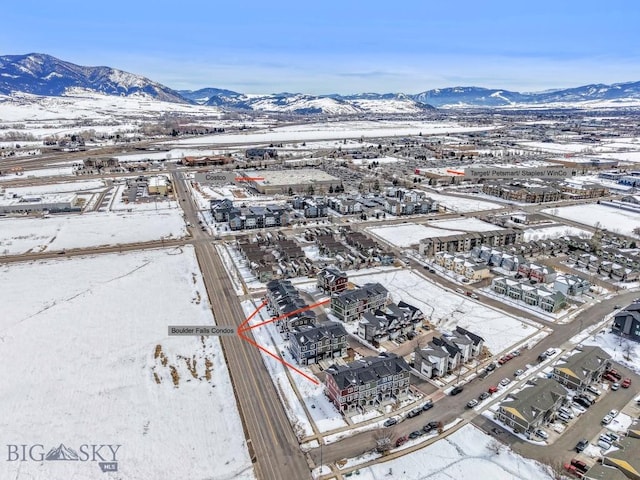 snowy aerial view featuring a mountain view