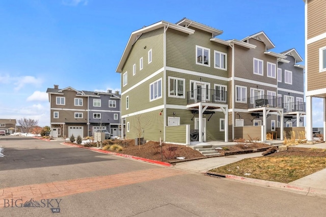 view of property with a residential view and central AC