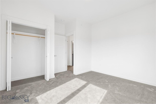 unfurnished bedroom featuring a closet, baseboards, and carpet flooring