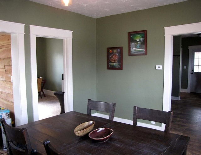 dining room featuring wood finished floors and baseboards