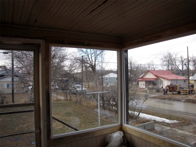 unfurnished sunroom with wooden ceiling and plenty of natural light