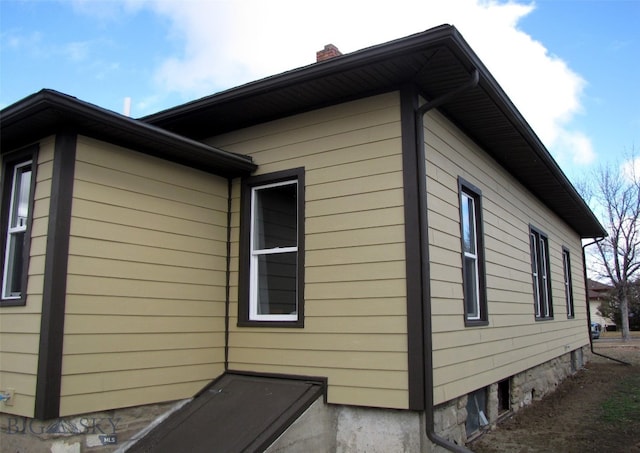 view of property exterior featuring a chimney