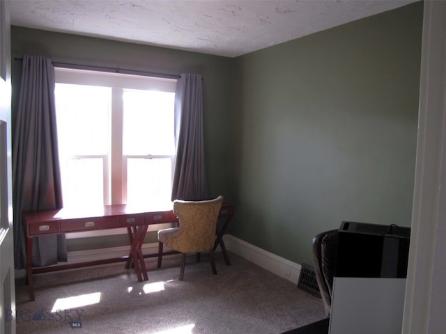 carpeted home office featuring baseboards