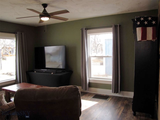 living area featuring ceiling fan, a healthy amount of sunlight, and wood finished floors