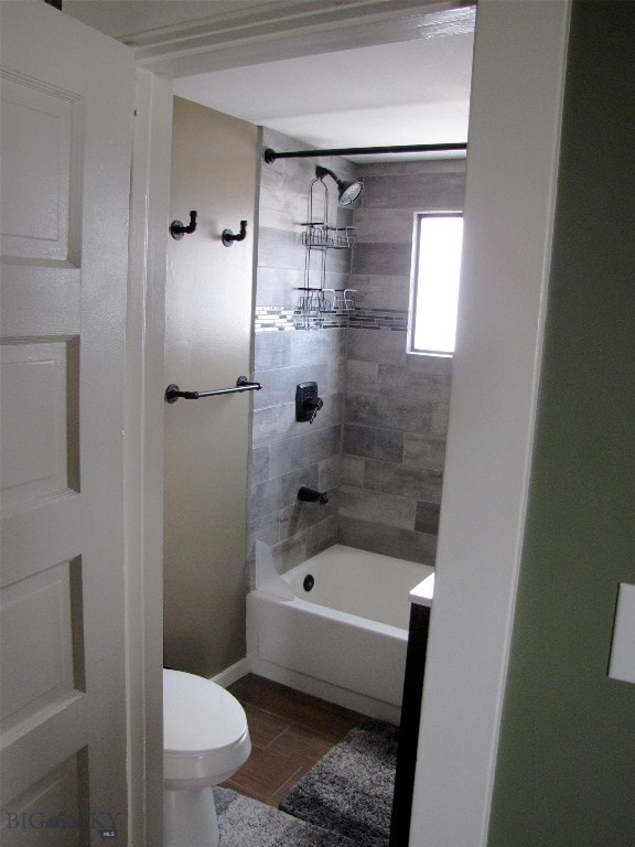 bathroom featuring shower / tub combination and toilet