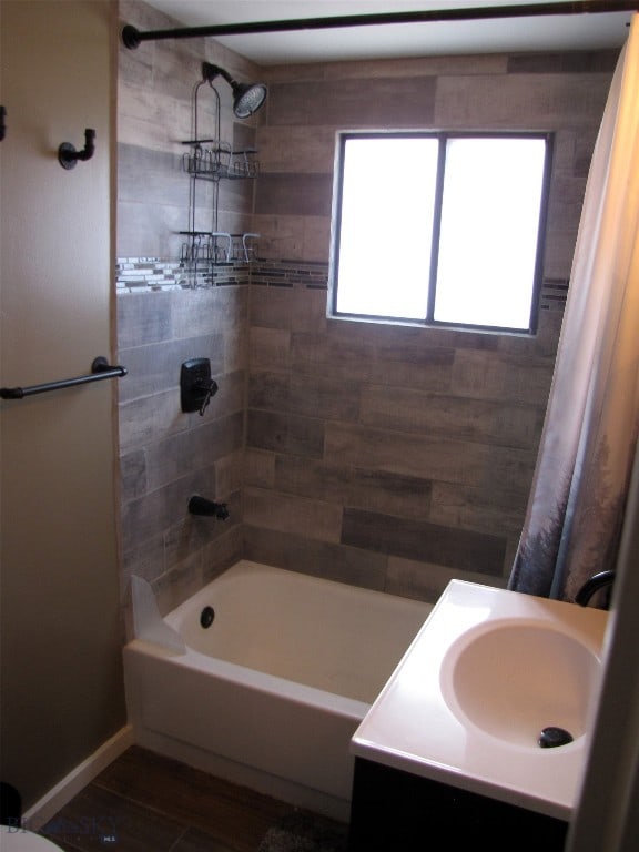 bathroom with vanity, wood finished floors, and shower / bath combo