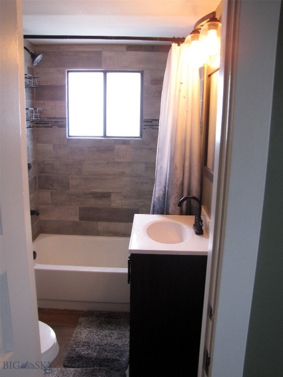 full bath with vanity, shower / tub combo, and toilet