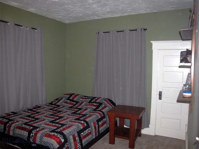 carpeted bedroom with a textured ceiling