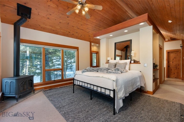 carpeted bedroom with lofted ceiling, recessed lighting, wooden ceiling, baseboards, and a wood stove