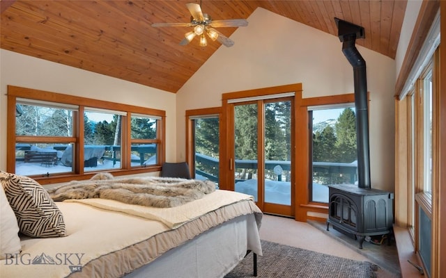 carpeted bedroom with multiple windows, wood ceiling, and a wood stove