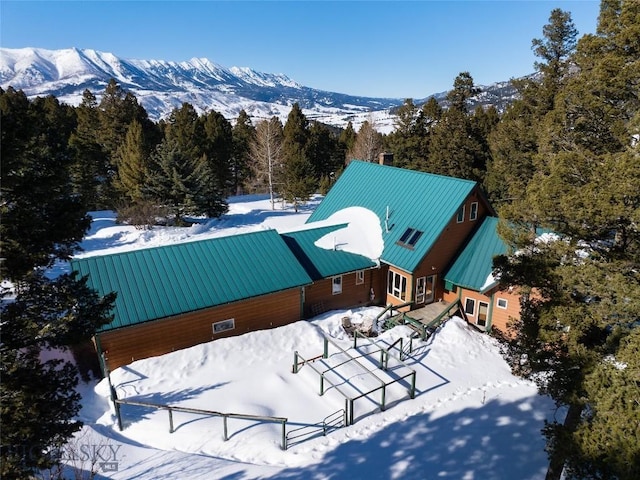 snowy aerial view with a mountain view