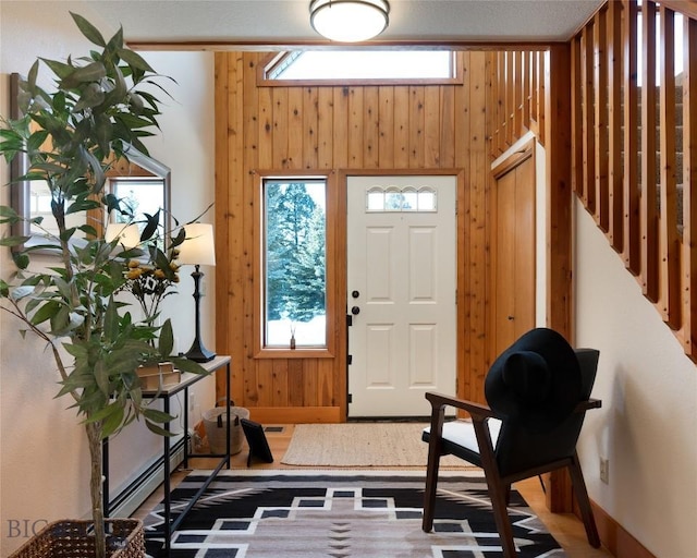 entryway featuring a wealth of natural light and wooden walls