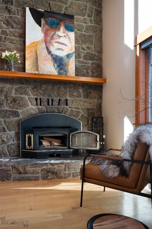 interior details featuring wood finished floors and a wood stove