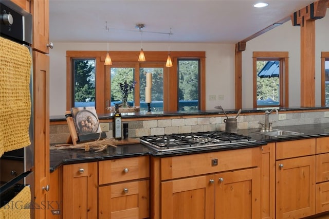 kitchen featuring a sink, plenty of natural light, tasteful backsplash, and stainless steel gas cooktop