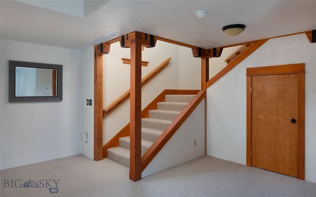 staircase with visible vents and carpet