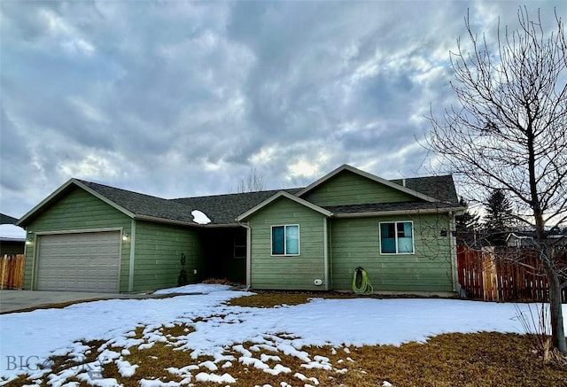 single story home with fence and a garage