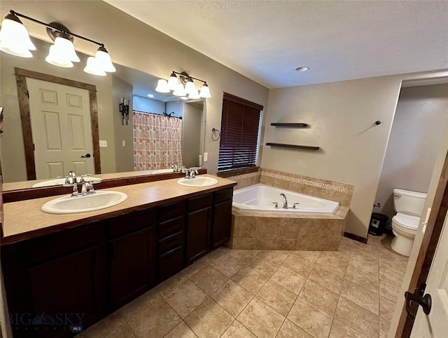 full bathroom featuring tile patterned floors, a garden tub, toilet, a sink, and double vanity